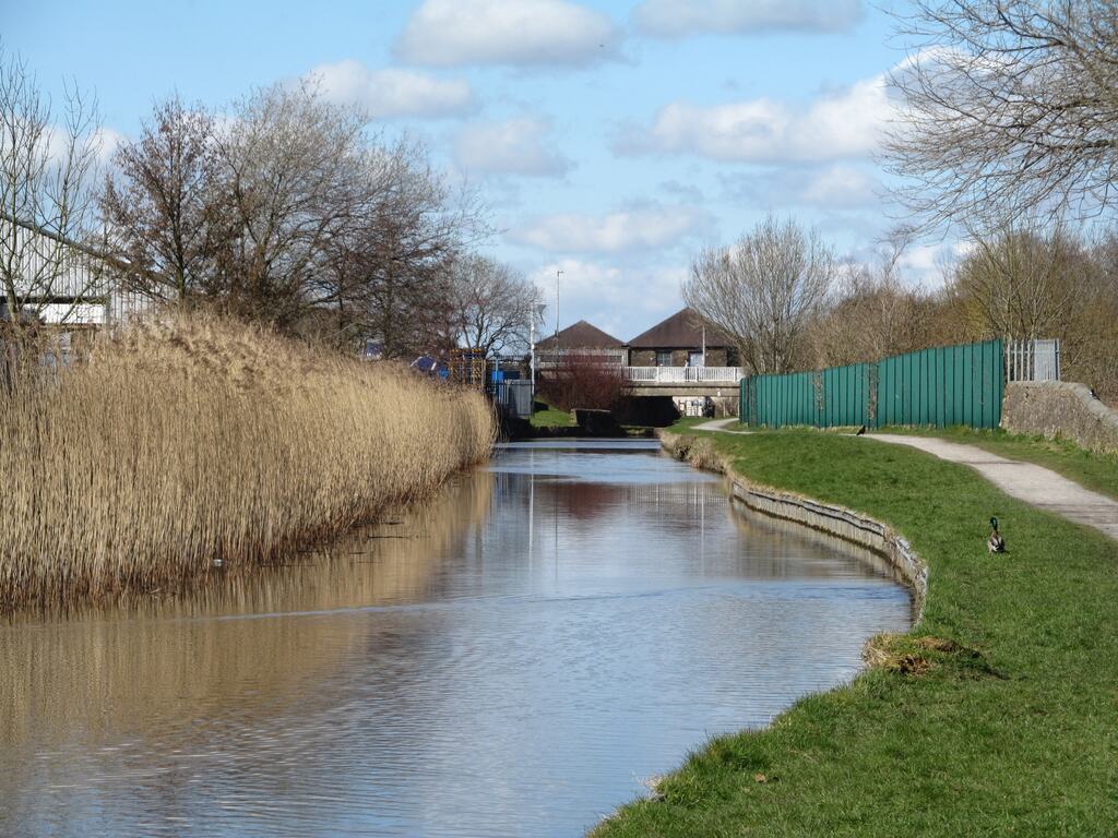 The Leeds and Liverpool Canal running past mill buildings at Barnoldswick